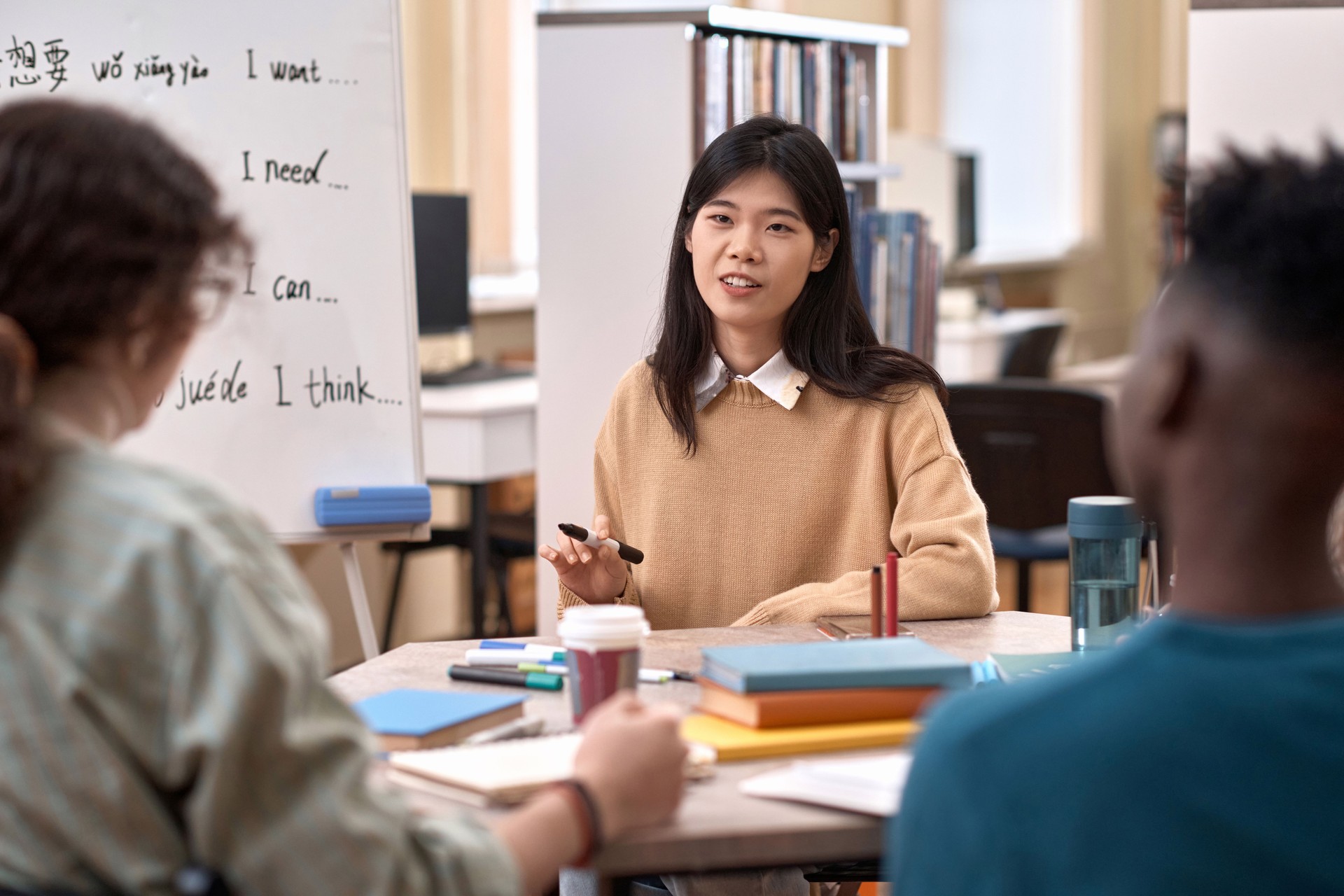Female Teacher Talking To Group of Students